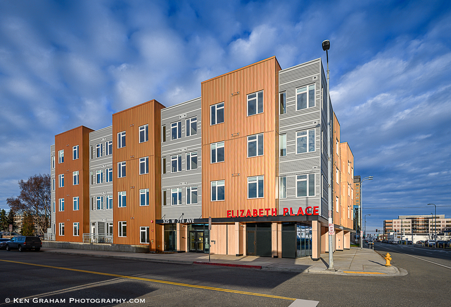Elizabeth Place apartment building with modern gray and orange siding on West 7th Avenue in Anchorage