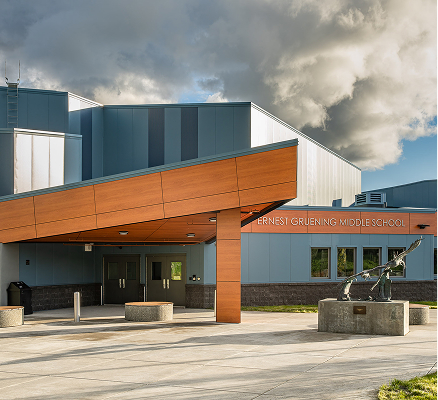 Entrance of Ernest Gruening Middle School with modern design and angled wood canopy