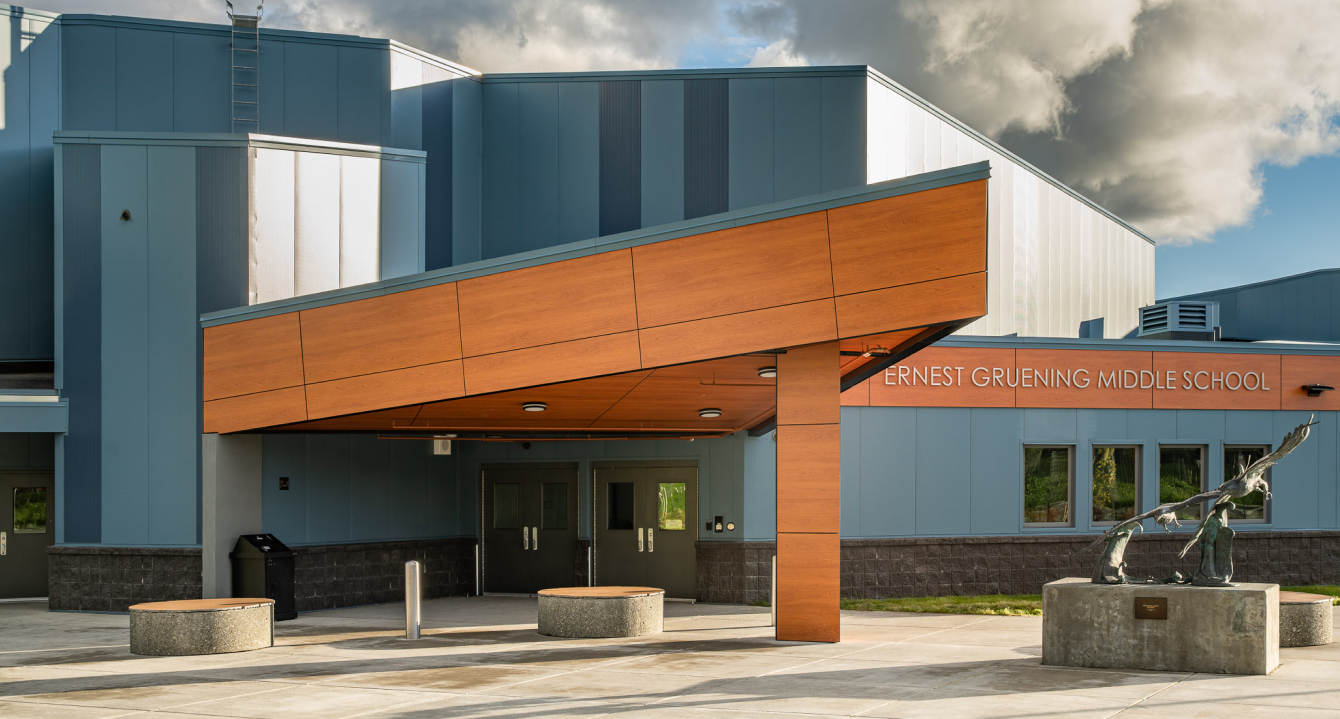 Entrance of Ernest Gruening Middle School with modern design and outdoor sculpture